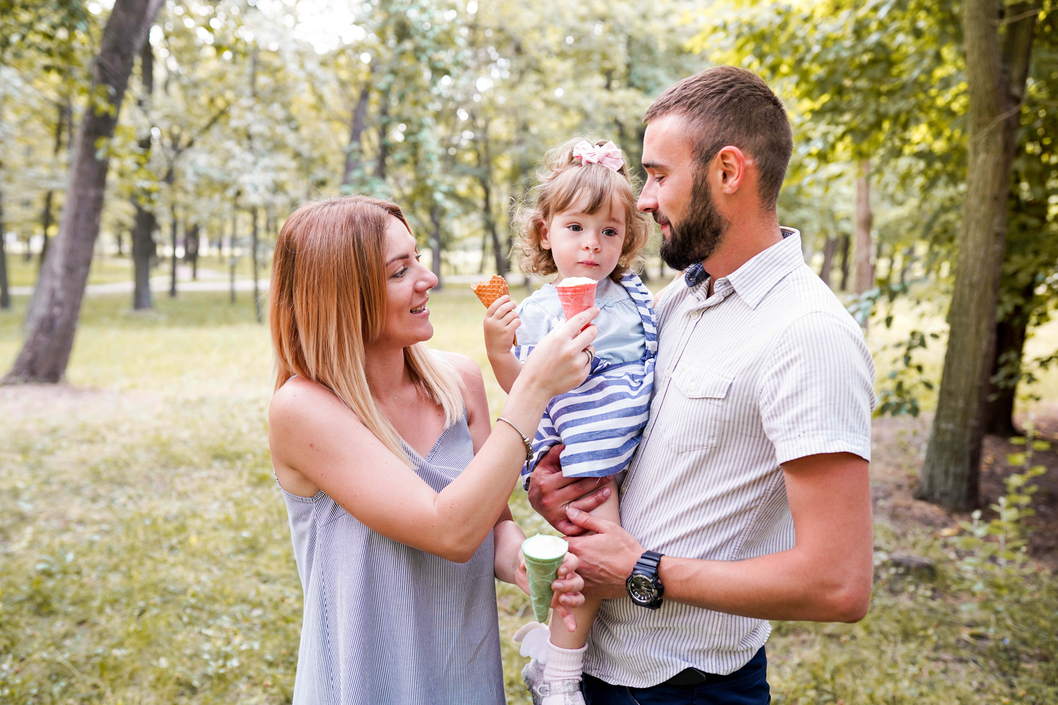 Man holding child with woman holding and ice cream cone