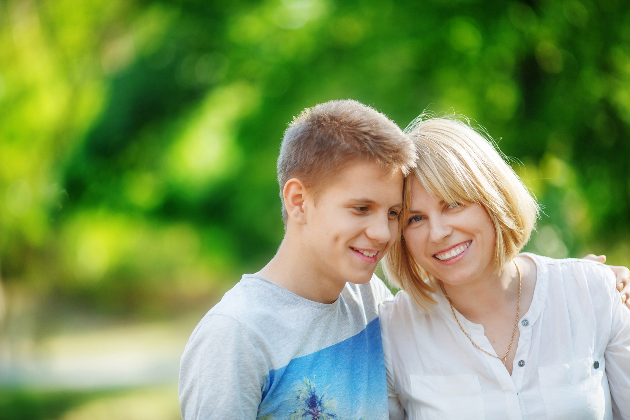 Woman and boy looking off camera smiling