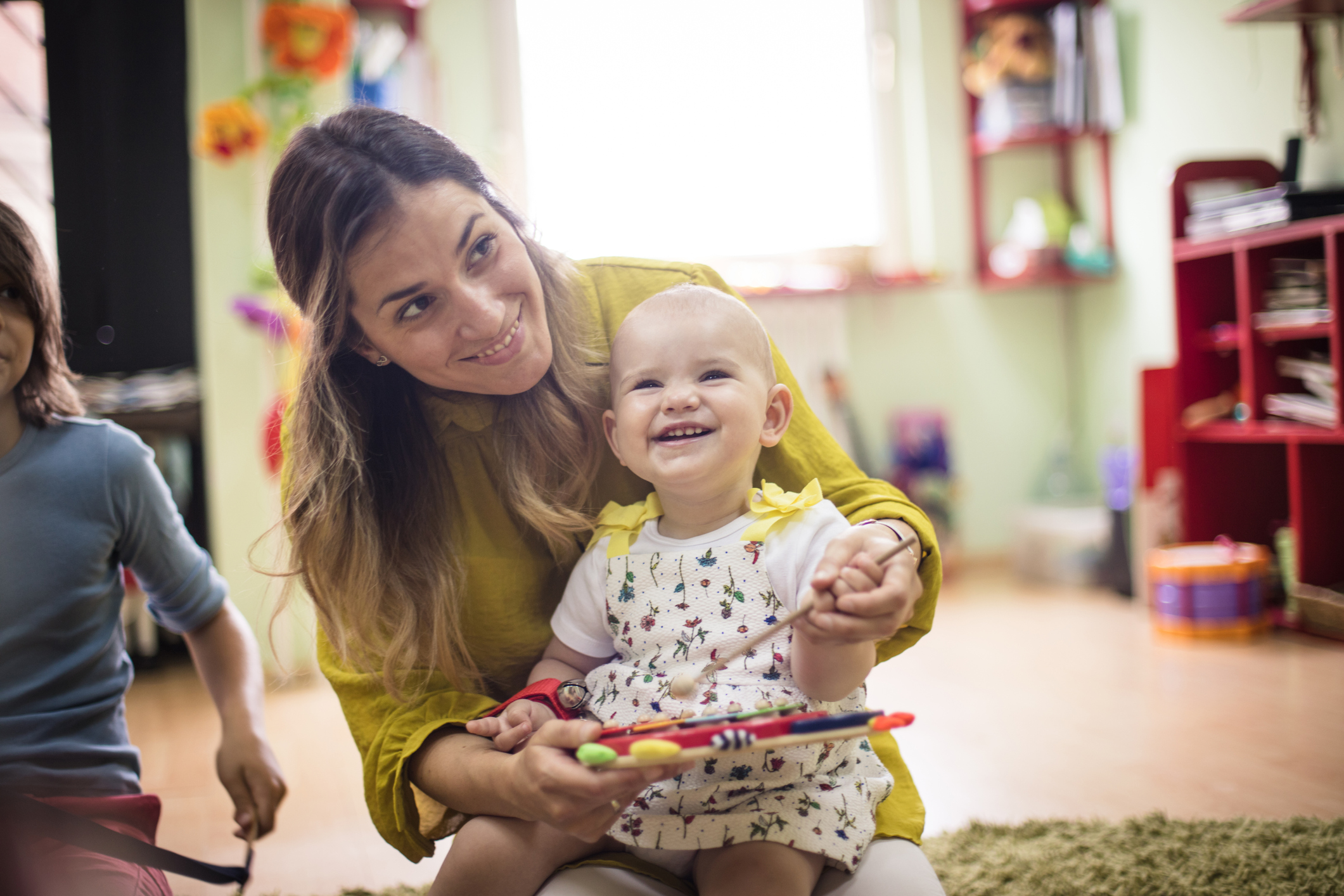 Photograph of woman holding young girl and smiling at camera