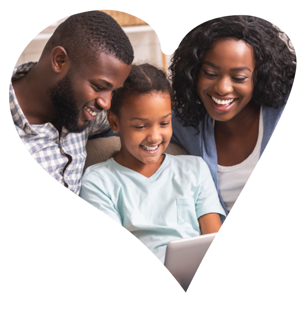 A smiling family of a man, young girl and women smiling together looking at a tablet device held by the girl